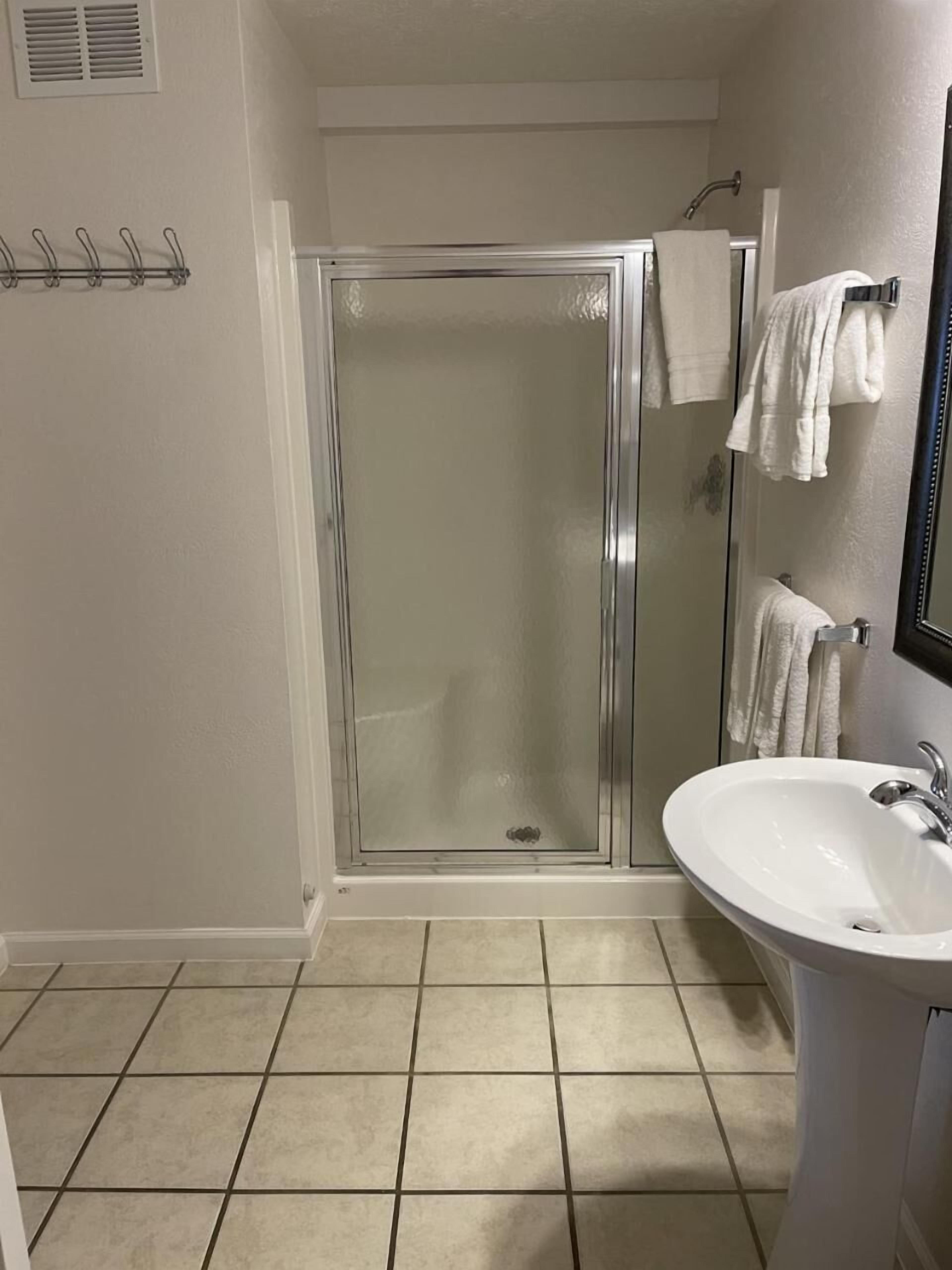 shower, hair dryer, towels, soap