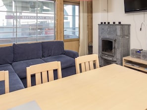 A room with a sofa, a table, and a fireplace.