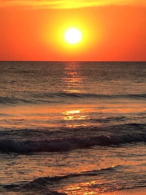 A sunset over the ocean with waves reflecting the sunlight. - Sparkling Clean, Updated 2BR/1BA Beach Condo. Unbeatable Location. (Longboat Key)
