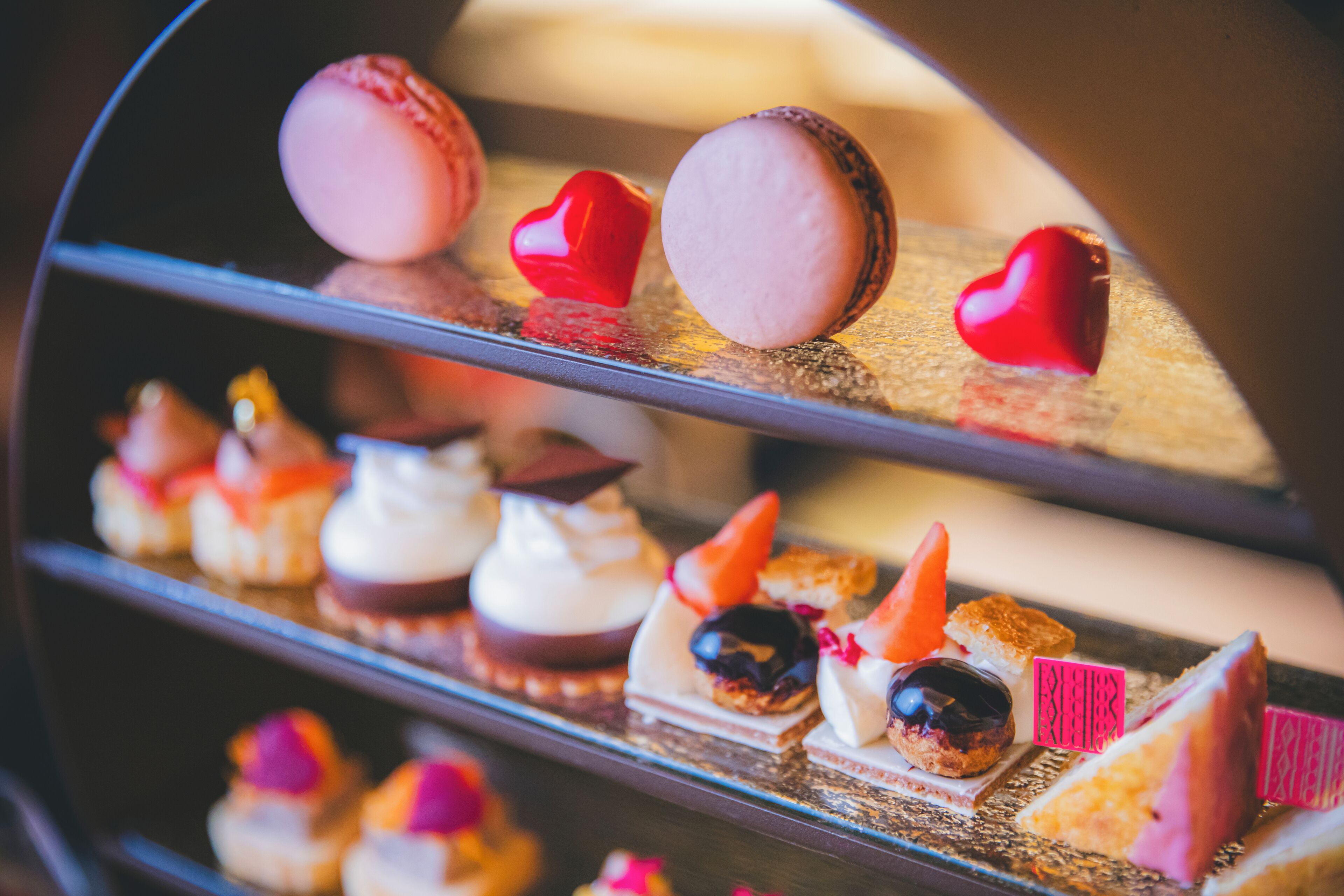A dessert display with macarons and various small pastries.