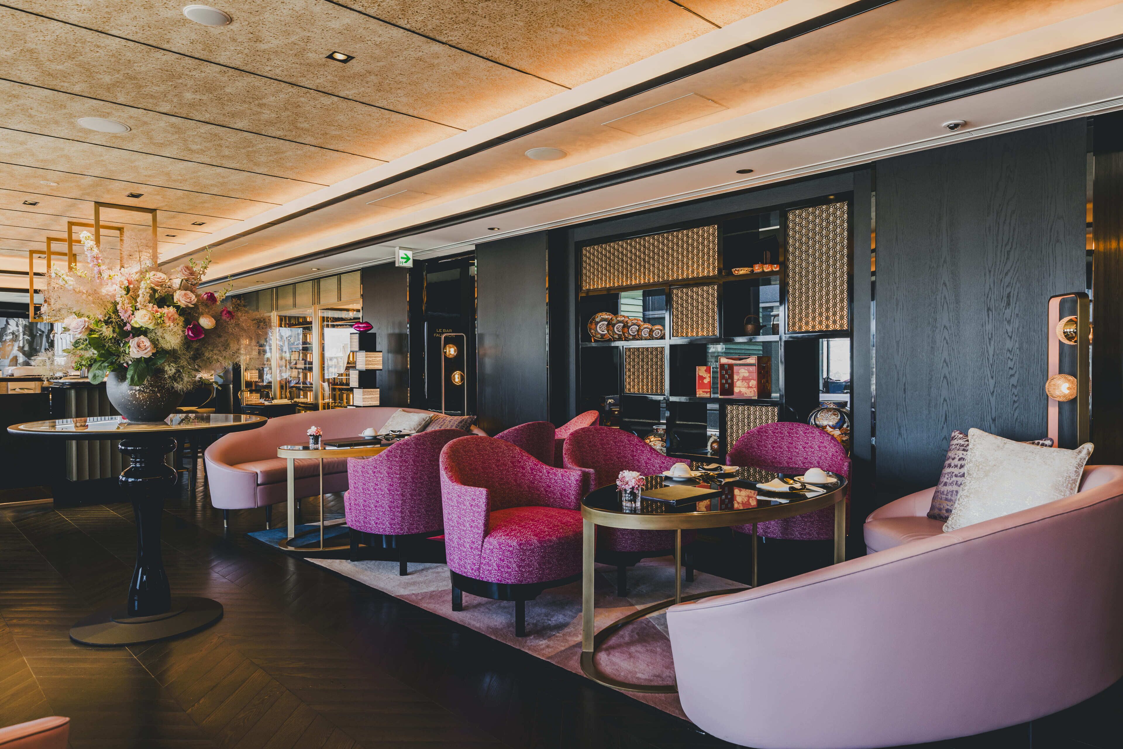 A modern lounge area with seating, a coffee table, and a decorative vase.