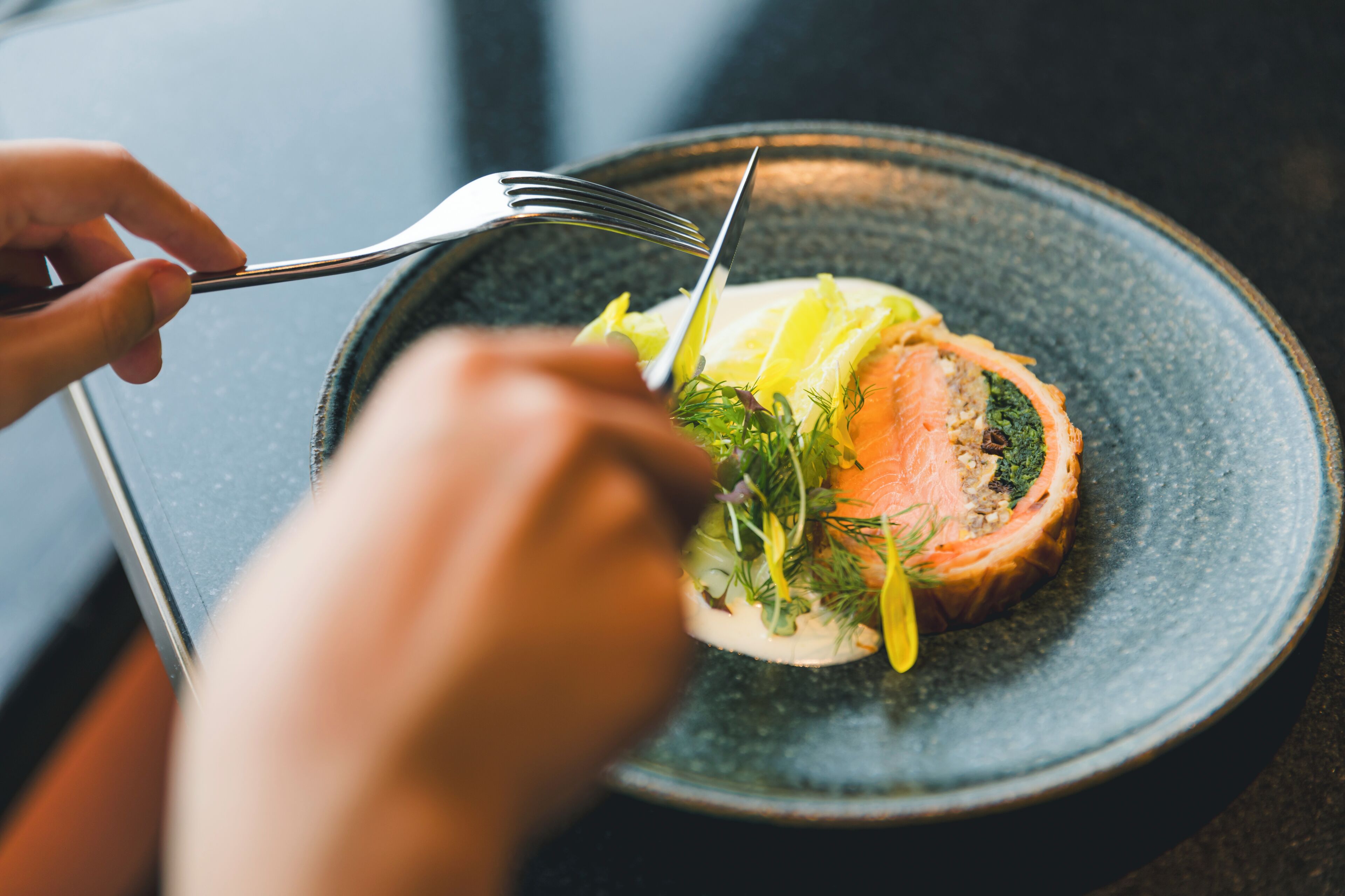 A plate with food, a fork, and a knife.