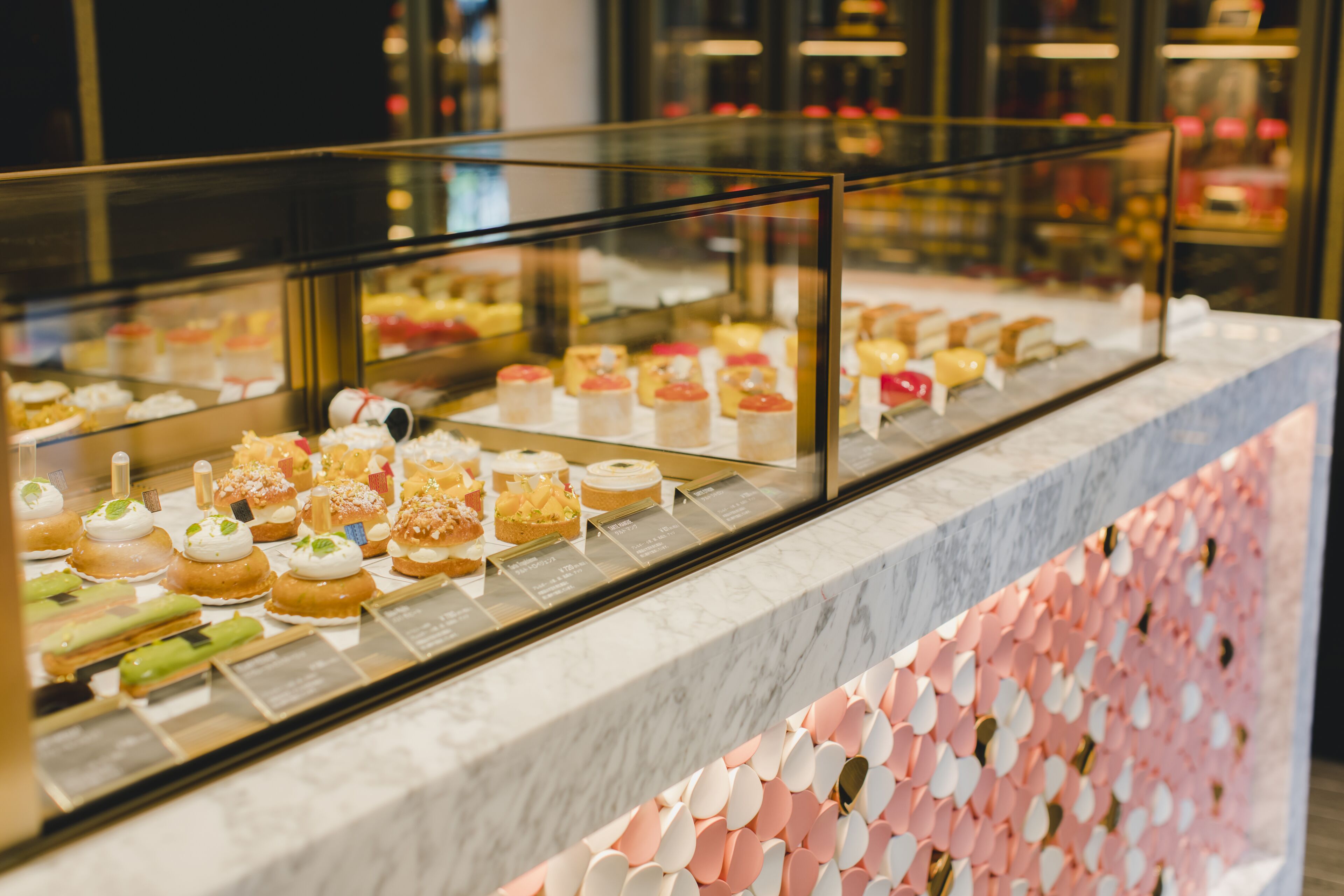 A display case with various pastries and desserts.
