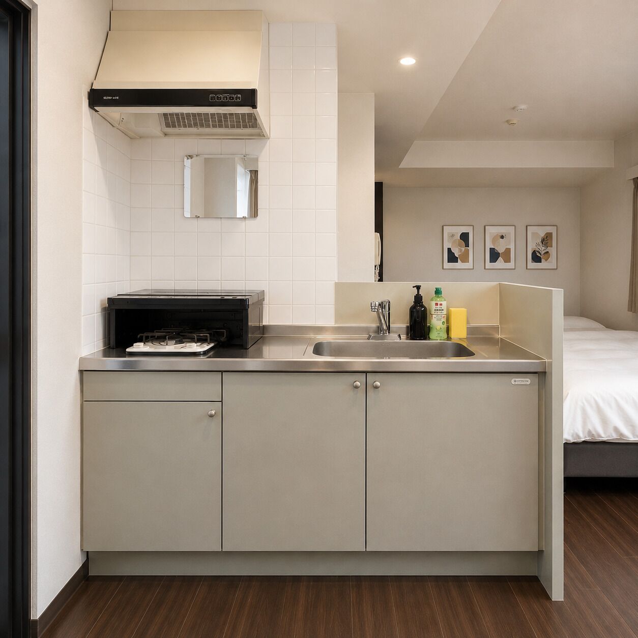 A compact kitchen with a gas stove, a sink, and a cabinet.