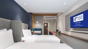 A modern hotel room with a large bed, a desk, and a television displaying the Holiday Inn Express logo. - Holiday Inn Express Foshan Chancheng (Foshan)