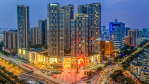 A high-rise urban area with multiple buildings, a central plaza, and a busy street. - Holiday Inn Express Foshan Chancheng (Foshan)