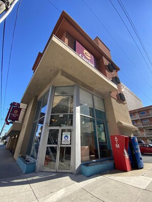 A hotel with a glass facade, an ATM, and a safety sign. - Clarion Inn Atlantic City - Beach and Boardwalk (Atlantic City)