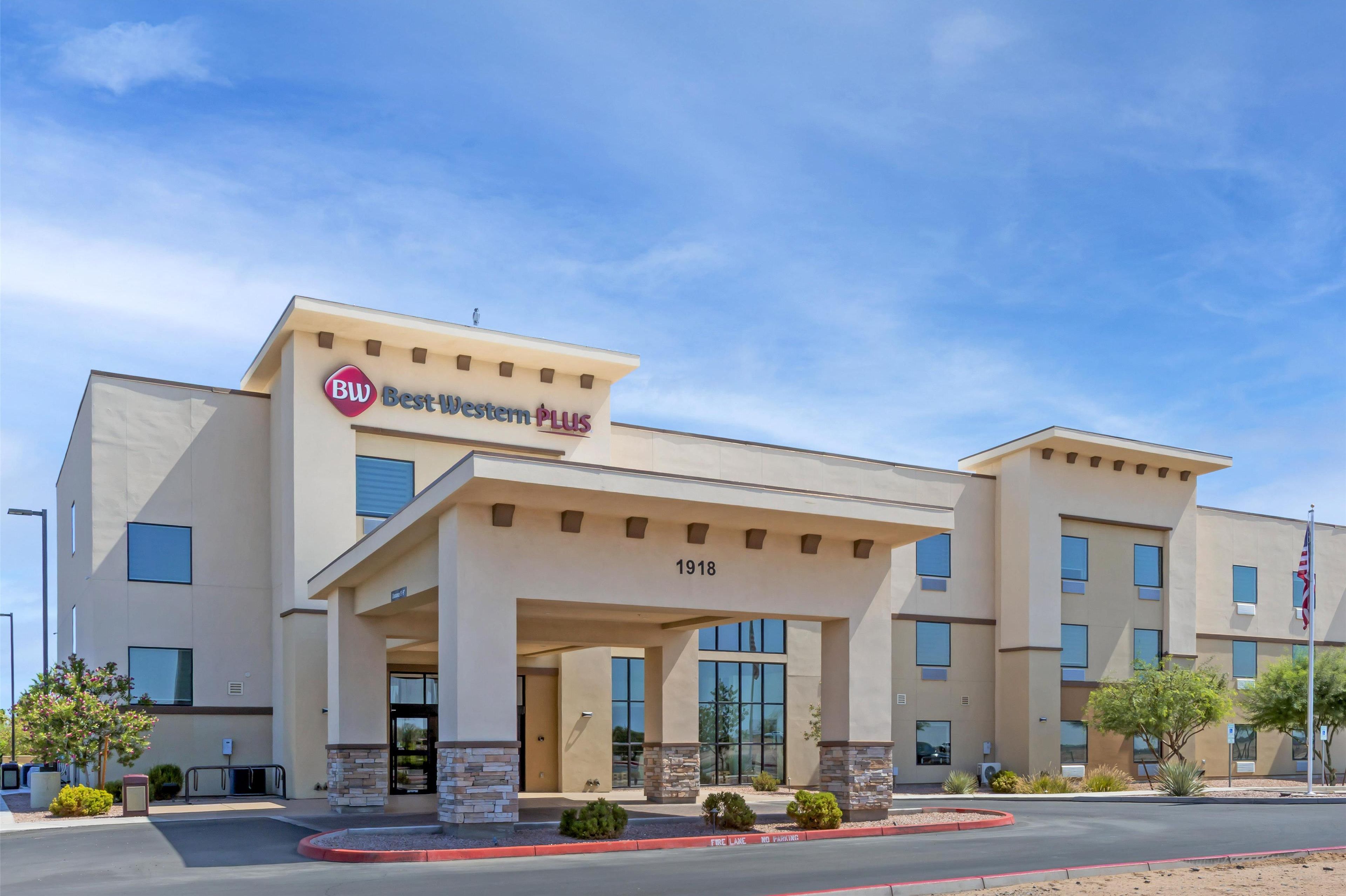 A Best Western PLUS hotel with a modern facade, numbered address, and a landscaped entrance.