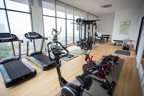 A gym with treadmills, elliptical machines, and a stationary bike. - ibis Styles Kota Bharu (Kota Bharu)