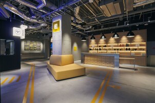 A modern interior with a sofa, a counter with various items, and a sign labeled "01".