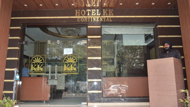 The entrance of Hotel KK Continental with a reception desk and glass doors. - Hotel KK Continental (Amritsar)