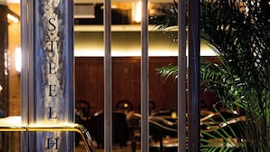 A bar with a sign reading "STELH" and a plant to the right. - The Steel House (Kitakyushu)