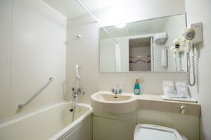 A bathroom with a bathtub, a sink, a mirror, and a hairdryer mounted on the wall. - The Steel House (Kitakyushu)