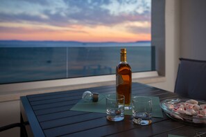 Enjoy a refreshing drink on the balcony with a stunning sea view.