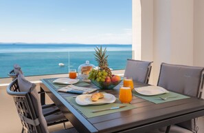 Enjoy a leisurely breakfast on the balcony with a serene view of the water.