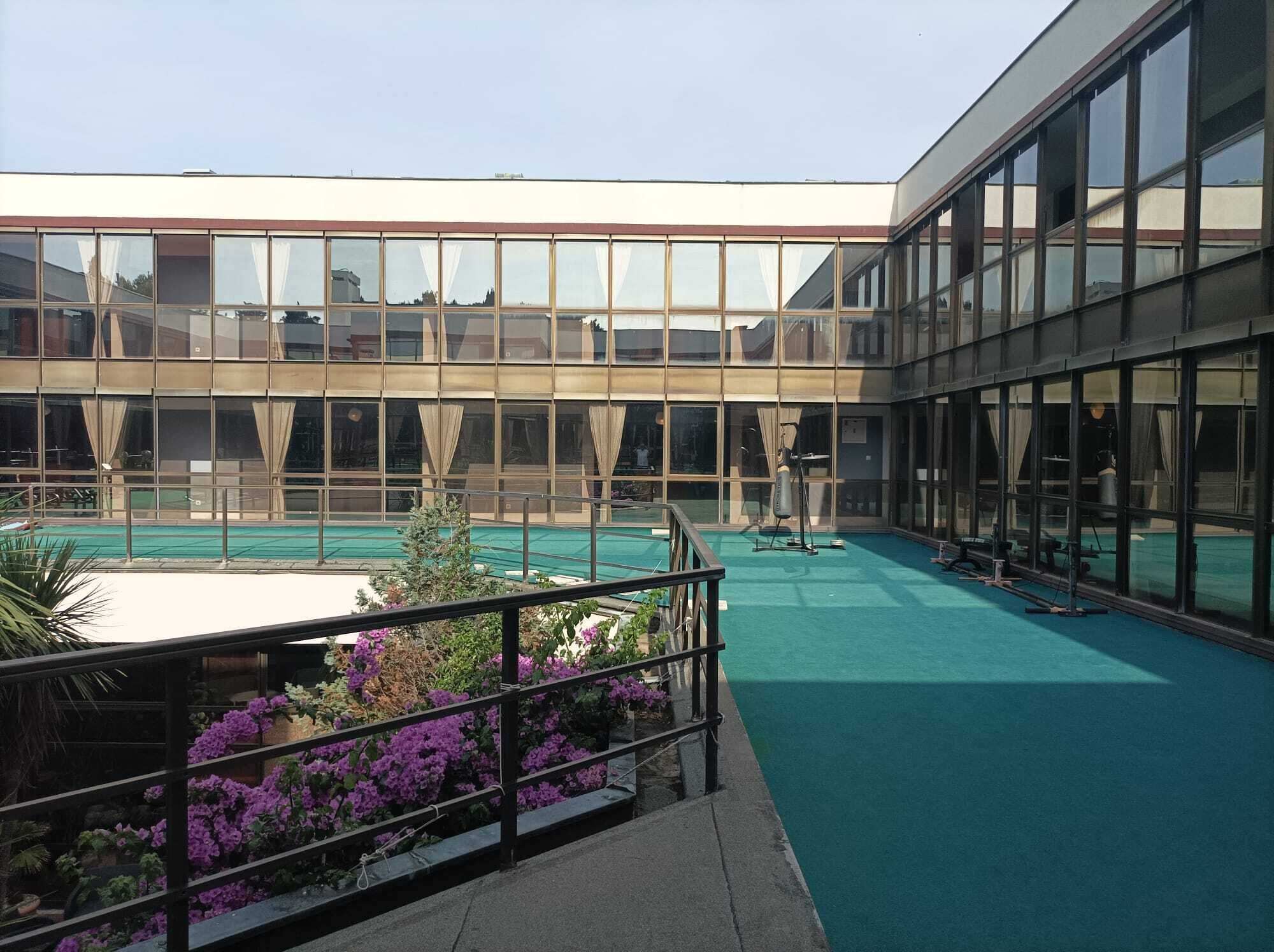 A modern building with a swimming pool and exercise equipment.