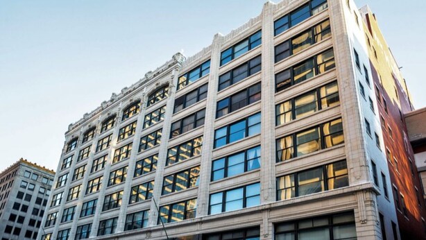 A multi-story building with a symmetrical facade, large windows, and a classic architectural style. - TWO Urban 2BR 2BA Apartments by CozySuites (Indianapolis)