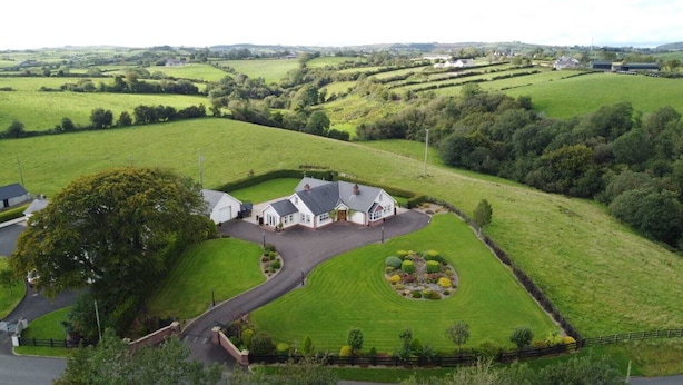 A large, white, two-story house with a driveway leading to a circular driveway. - Dungannon 2 Bed Bungalow - Sleeps 5 - Pet Friendly (Dungannon)