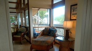 A cozy room with a bed, a chair, a table, and a window with a view of the outdoors. - Beautiful Waterfront Large Private Gulfside Home Family Friendly.  (Marathon)