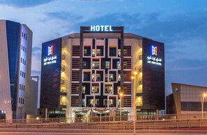 A modern hotel with a prominent 'HOTEL' sign at the top.