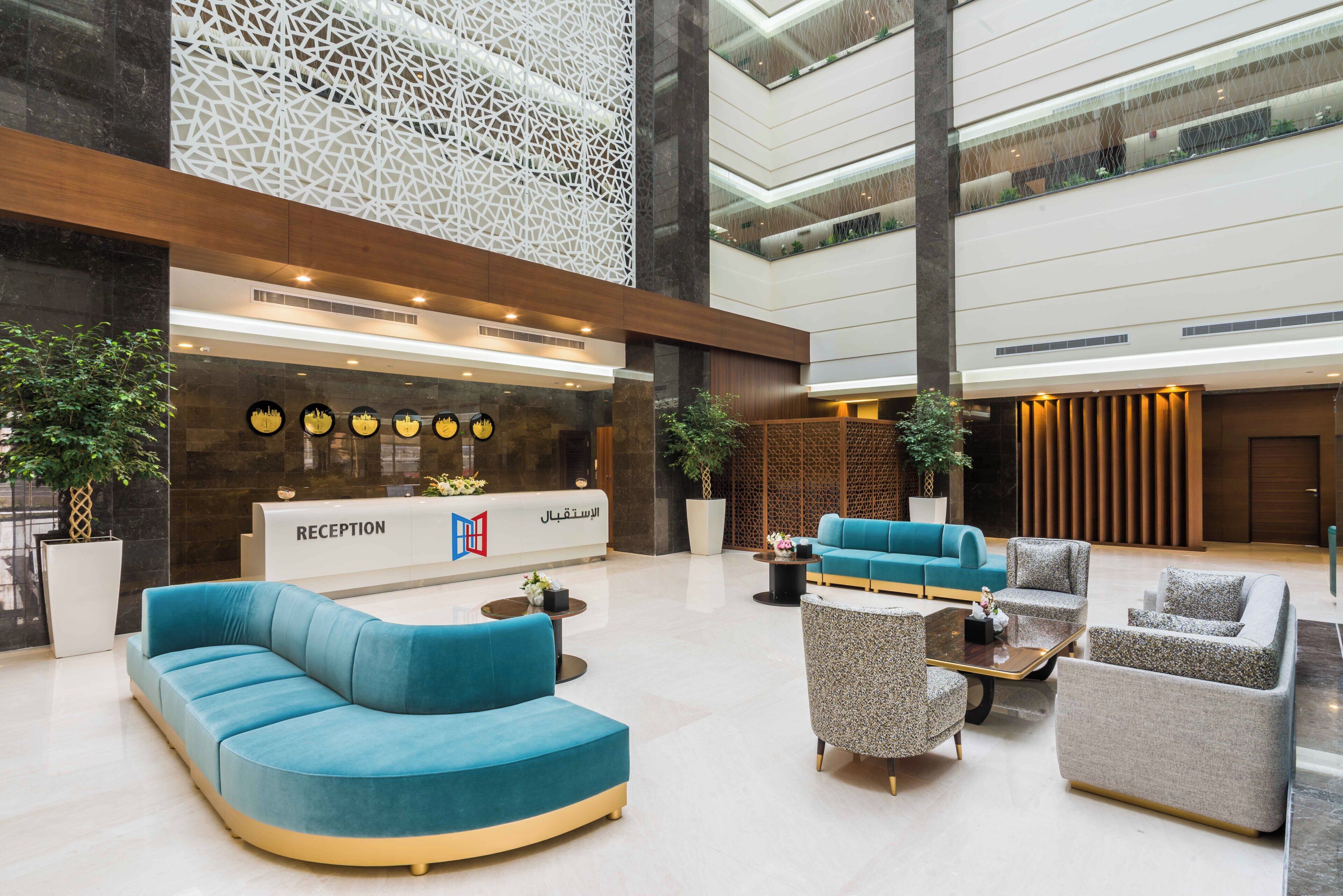 A modern reception area with a reception desk, seating arrangements, and decorative elements.