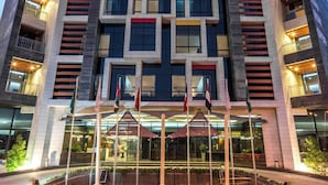A modern hotel building with a prominent "HOTEL" sign at the top.