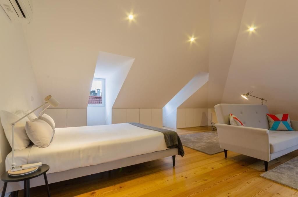 Une chambre à coucher moderne avec un lit, une chaise et un bureau.