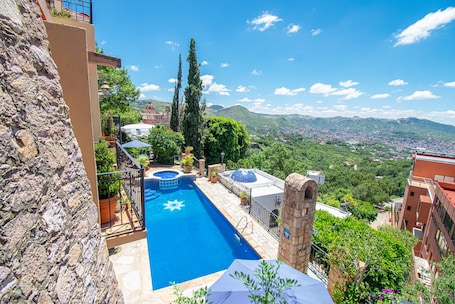 Seasonal outdoor pool, open 8:00 AM to 8:00 PM, pool umbrellas