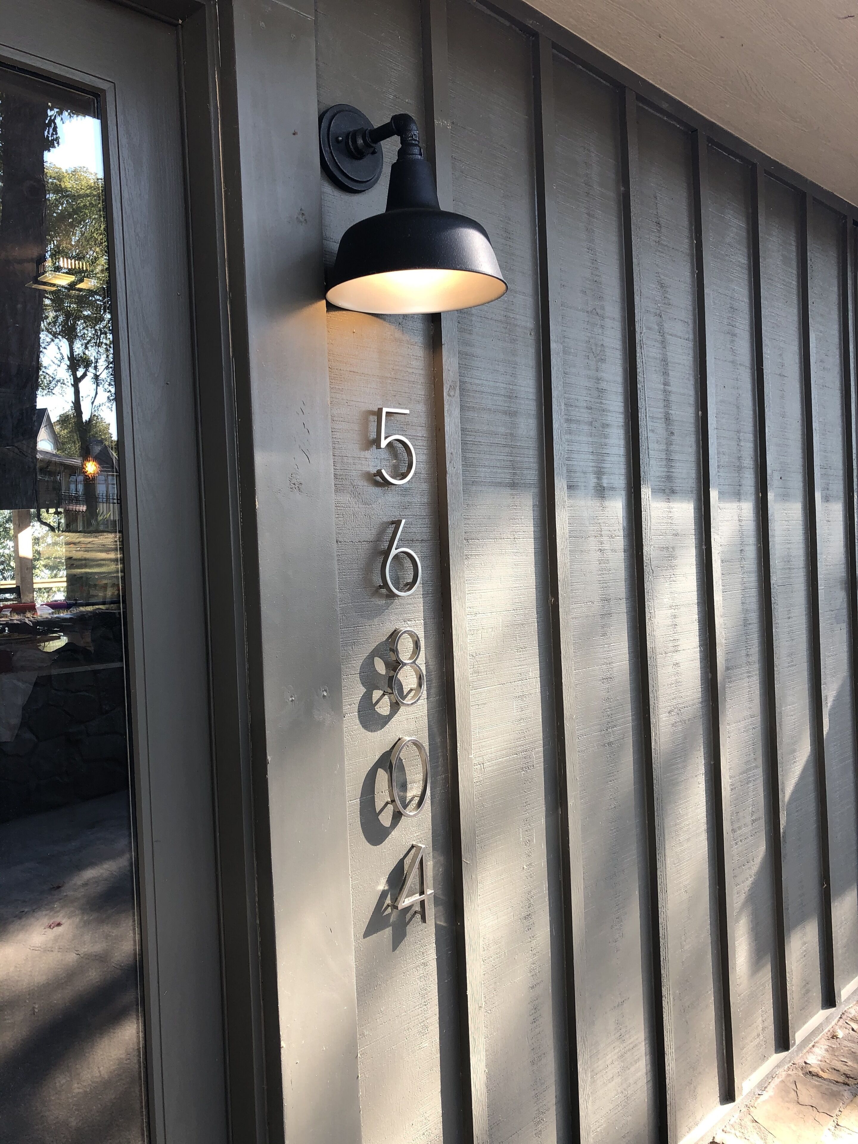 A wall-mounted light fixture with a number "568" on a metallic surface.