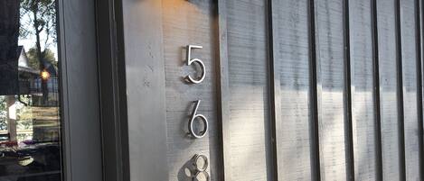 A wall-mounted light fixture with a number "568" on a metallic surface.