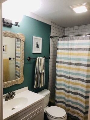 Bathtub, hair dryer, towels, soap