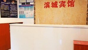 A reception desk with a sign that reads "滨城宾馆" (Binh City Inn). - Beijing Bincheng Hotel (Tongzhou)