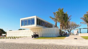 A modern building with a flat roof, large windows, and a sign reading "SIESTA BEACH". - Clean & Modern, Close to Beach, Restaurants, Downtown SRQ! (Sarasota)