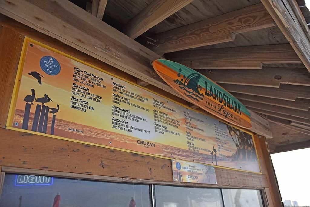 A menu board with various drink options and a sign for 'LANDSHARE' above it.