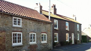 A row of two-story houses with stone and brick exteriors, red-tiled roofs, and white-framed windows. - 1 bedroom accommodation in Nordham, near Beverley (Nordham, near Beverley)