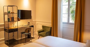 Relax in a serene space with a comfortable bed, desk, and green armchair.