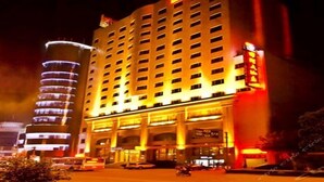 A multi-story hotel with a prominent entrance and a large sign. - International Hotel (Jiaxing)
