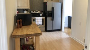 A kitchen with wooden cabinets, a black microwave, a stainless steel stove, and a double-door refrigerator. - Beautiful Marina Home - 2Bed 2Bath - 1 block from Marina Blvd! (San Francisco)