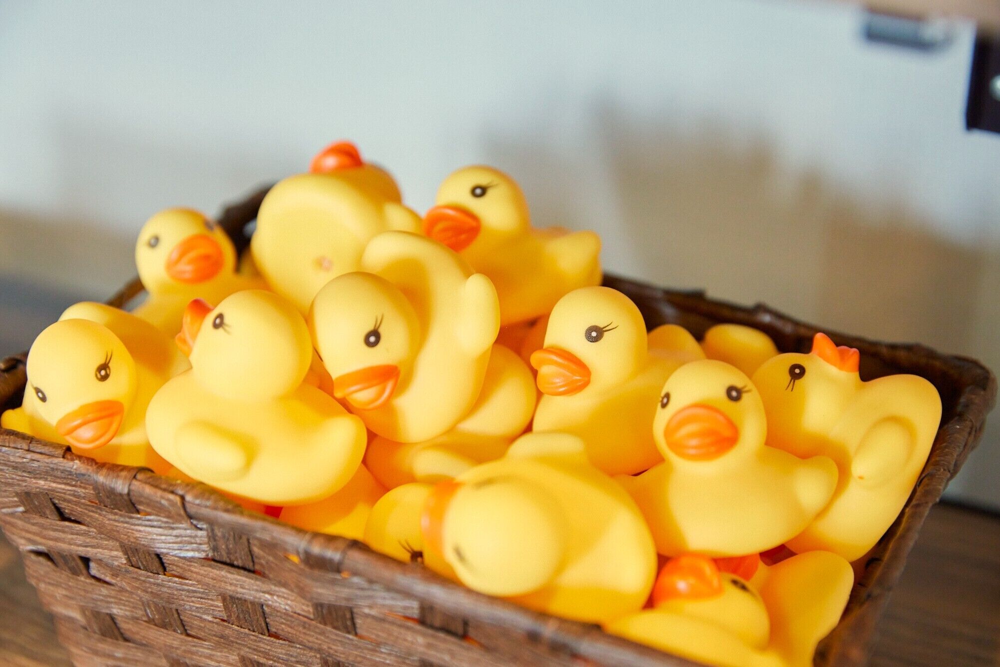 A basket filled with yellow rubber ducks.