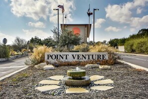 A sign reading "POINT VENTURE" with a fountain and decorative stones in front.