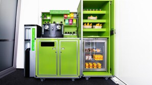 A compact kitchenette with a coffee station, water station, and a mini-fridge stocked with snacks. -  flexy.motel Wil (Wil)