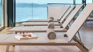 A row of sun loungers with towels and a book on one of them. - Aminess Style Glamping Villas & Holiday Homes Atea (Omisalj)
