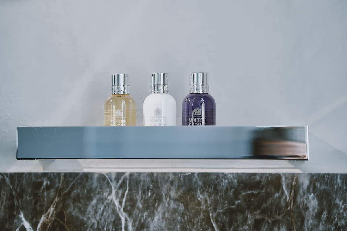 shower, designer toiletries, hair dryer, slippers