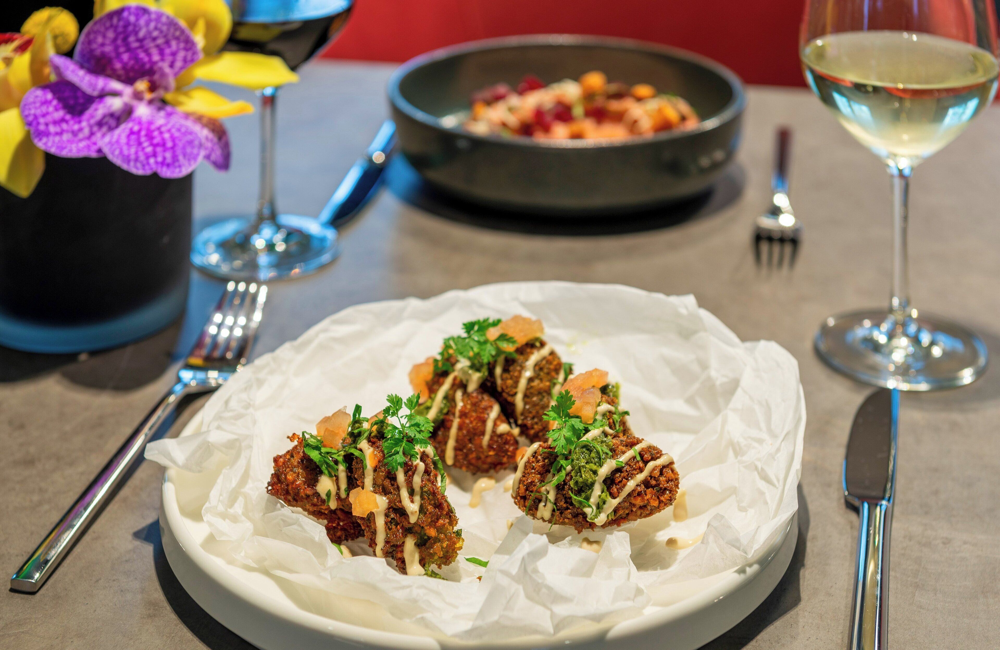 A plate of food with a fork and knife on the table.