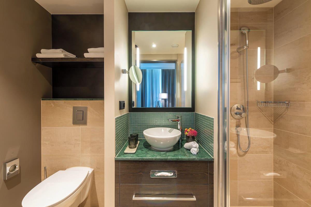superior double room | bathroom | shower, rainfall showerhead, hair dryer, towels