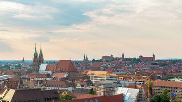 A cityscape with historic buildings and a prominent church tower.