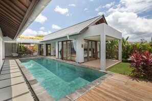 A modern house with a swimming pool, covered patio, and garden. - Villa Ciwuwi Balangan by Nagisa Bali (Jimbaran)