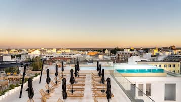 Indoor pool, outdoor pool, pool umbrellas, pool loungers