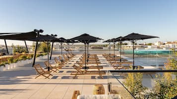 Indoor pool, outdoor pool, pool umbrellas, pool loungers