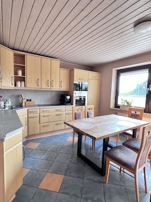 Enjoy meals in the kitchen with an oven and microwave, and dine at the central dining table.